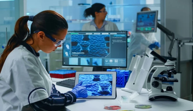 A lab technician analyzing virus evolution looking at a digital tablet team of scientists conducting vaccine development using high tech for researching treatment against the COVID-19 pandemic.